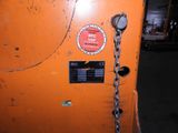 an orange machine with a chain attached to it ' s side