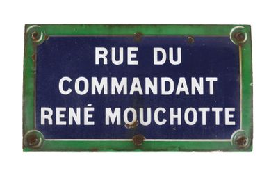 blue and white street sign on a green metal plate with rusted edges