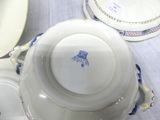 a white plate with a blue bird on it on a table