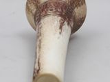 a white and brown vase on a white surface