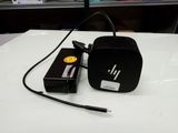 a black hp power adapter sitting on a white table