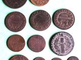 several different types of coins are shown on a white surface