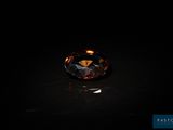 a brown diamond sitting on top of a black surface