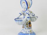 a figurine of a woman in a blue and white dress