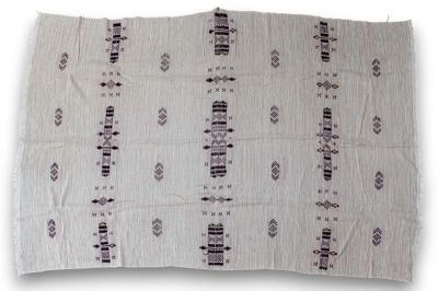 an image of a white rug with black and white designs on it