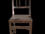 a wooden chair with a wooden seat on a black background
