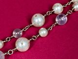 pearl and amethe necklace on a pink background
