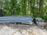 a pile of steel bars sitting on the ground in the woods