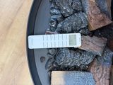 a remote control sitting on top of a pile of coal