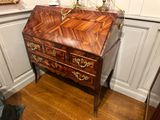 a wooden desk with a mirror on top of it