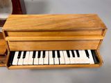 a small wooden box with a piano inside of it