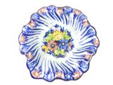 a blue and white plate with a flower design on it