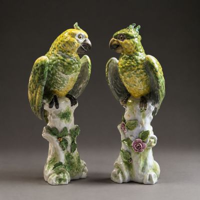 pair of green and yellow parrots sitting on a tree stump