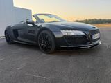 an image of a black sports car parked in a parking lot