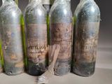 six bottles of wine are lined up in a row on a table