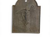 a statue of an angel on a plaque on the wall