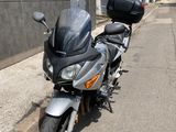 a motorcycle that is parked on the side of the street
