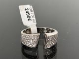 an image of a silver ring with diamonds on a black surface
