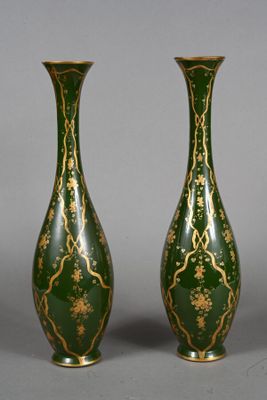 pair of green and gold vases on a gray background