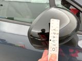 a person holding a measuring tape in front of a car