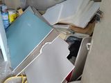a pile of assorted items in the corner of a room