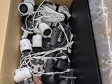 a cardboard box full of electronics and wires on the floor