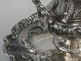 a silver plate with a silver lid on it