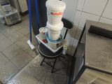 a stack of buckets sitting on a chair in a kitchen