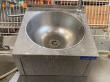 a sink that is sitting in the middle of a kitchen