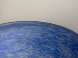 a blue and green vase sitting on top of a table