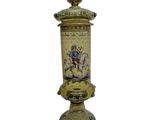 a gold vase with a picture of a man riding a horse on it