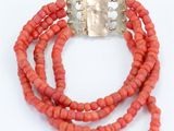 an image of a bracelet with coral beads and a silver clasp