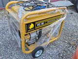 a portable generator that is sitting in the gravel