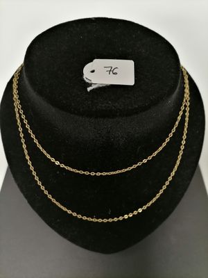 a black hat with a gold chain necklace on top of it