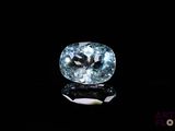 a close up of a blue diamond on a black surface