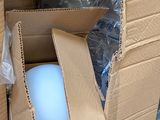 a white ball inside of a cardboard box on the floor