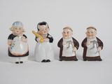 four ceramic figurines of people dressed in different outfits