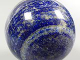 a close up of a blue and white marble ball on a stand