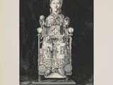 an old black and white photo of a statue of a woman