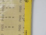 a yellow ticket with numbers on it sitting on a table