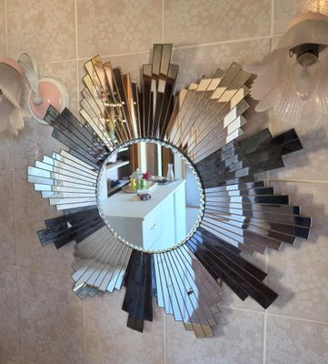 a mirror hanging on the wall in a bathroom
