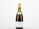 a bottle of wine sitting on top of a white table