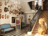 a picture of a room with a lot of antelope heads on the wall