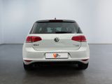 the rear end of a white volkswagen vw golf parked in a white room