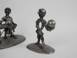 pair of antique pewware figurines of a boy and a girl