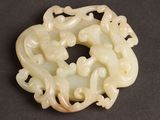 an image of a white jade broochle with a dragon on it