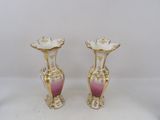 pair of pink and gold vases sitting on a white surface