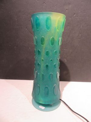 a green vase that is sitting on a table