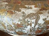 a vase with a bird on it sitting on a table