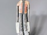 statue of a man in a gray suit with a red tie